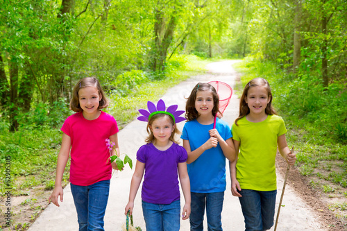 Friends and sister girls walking outdoor in forest track