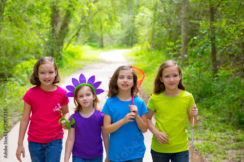 Friends and sister girls walking outdoor in forest track
