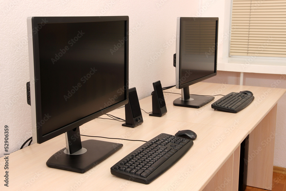 Computers on tables in room Computers on tables in room