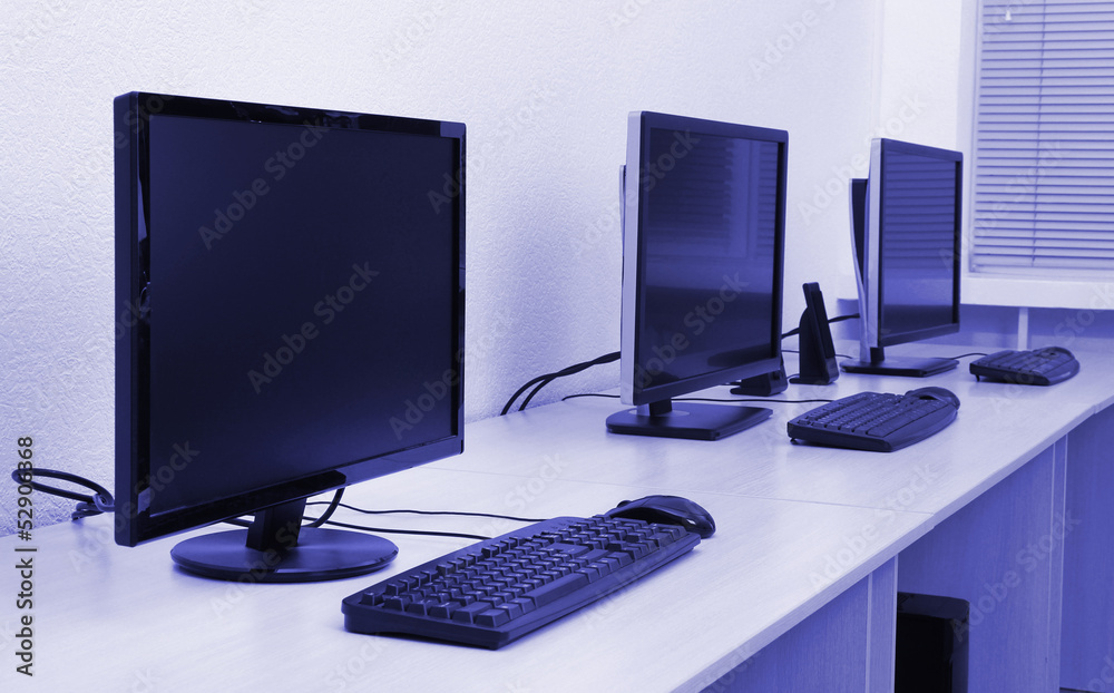 Computers on tables in room Computers on tables in room