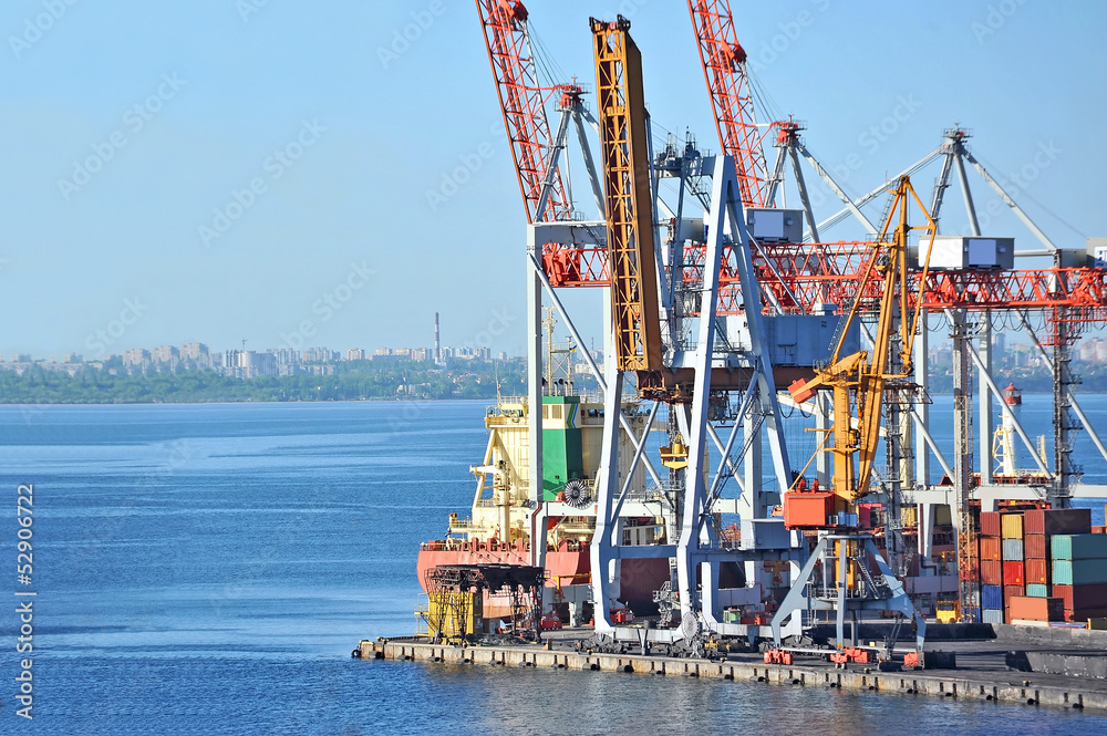 Fototapeta premium Container stack and ship under crane bridge