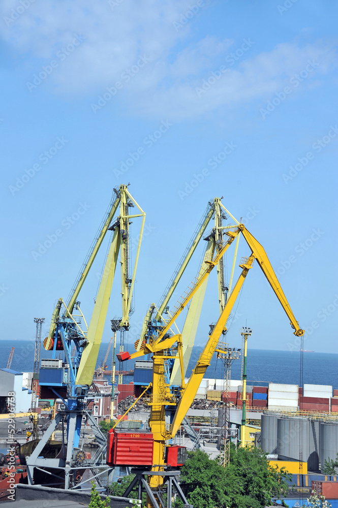 Port cargo crane and container over blue sky background Port cargo crane and container over blue sky background