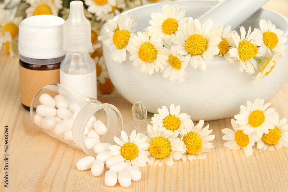 Medicine chamomile flowers on wooden table Medicine chamomile flowers on wooden table