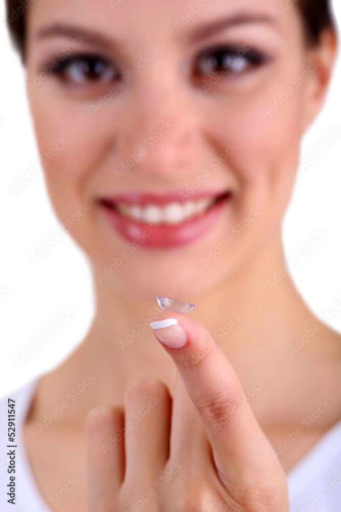 Young woman putting contact lens in her eye close up Young woman putting contact lens in her eye close up