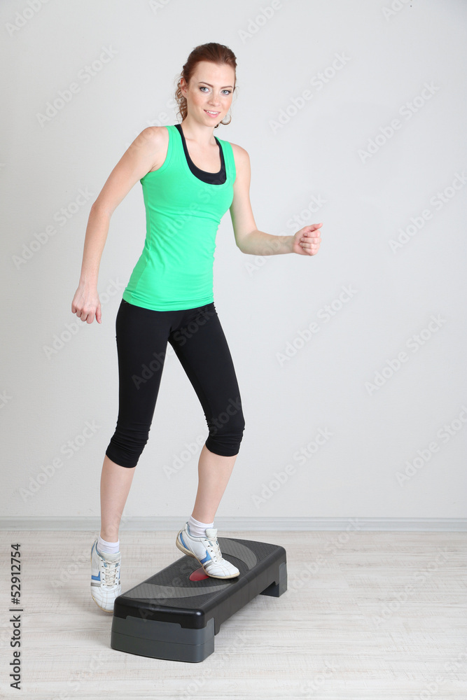 Beautiful young woman exercises on stepper Beautiful young woman exercises on stepper