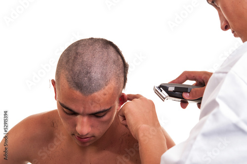 Barber cutting hair with clipper on white background