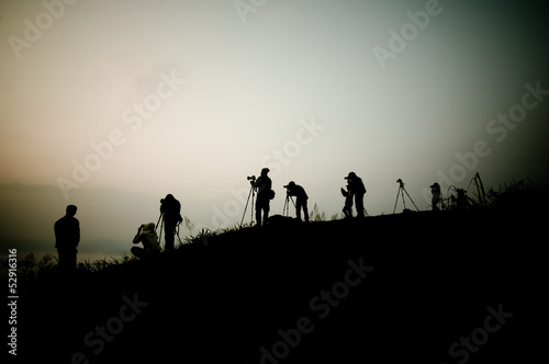 Silhouette of photography on the cliff. Phu Chee Fah Thailand.