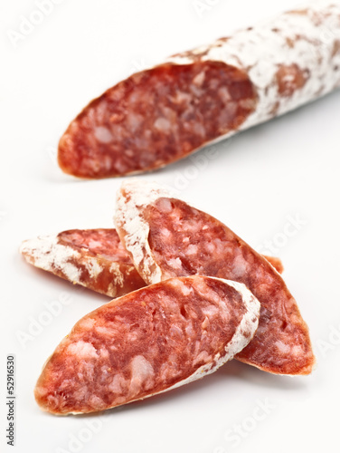 sliced fuet on white background