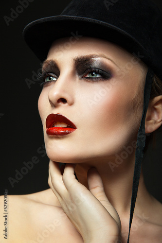 Fashion horsewoman wearing black hat © julenochek