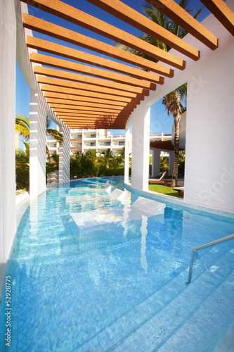 Swimming pool at caribbean resort. © grinny