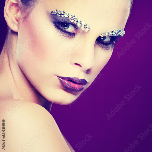 beautiful girl with strasses on face, on a violet