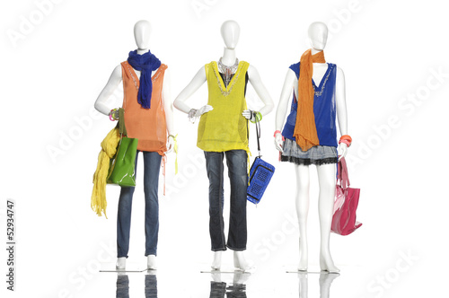 Full female clothes in scarf with bag on three mannequin