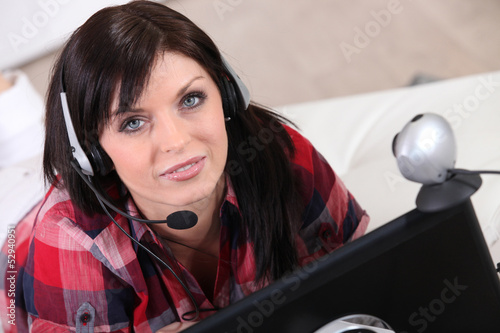 a woman communicating through a webcam photo