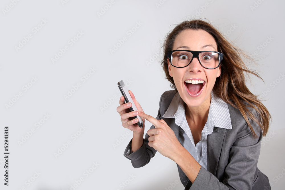 Business girl with funny look showing smartphone Business girl with funny look showing smartphone