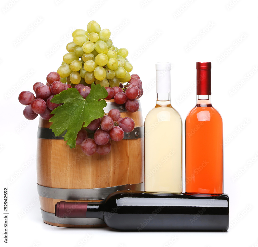 barrel and bottles of wine and ripe grapes on barrel