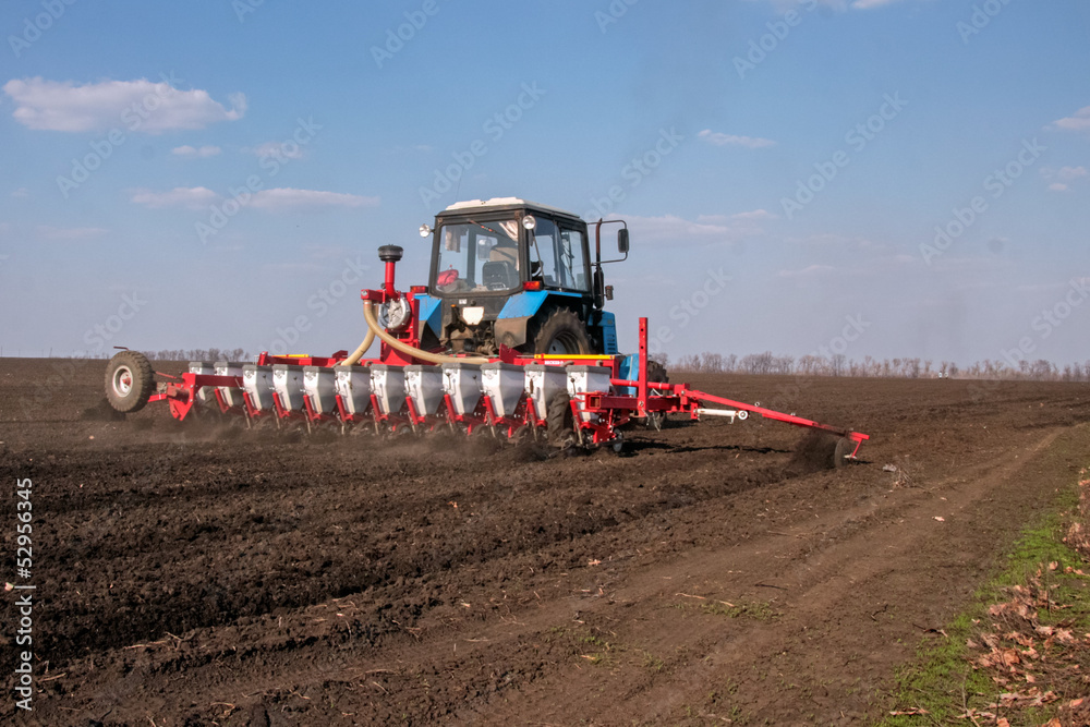 Obraz premium Tractor with sower on the field