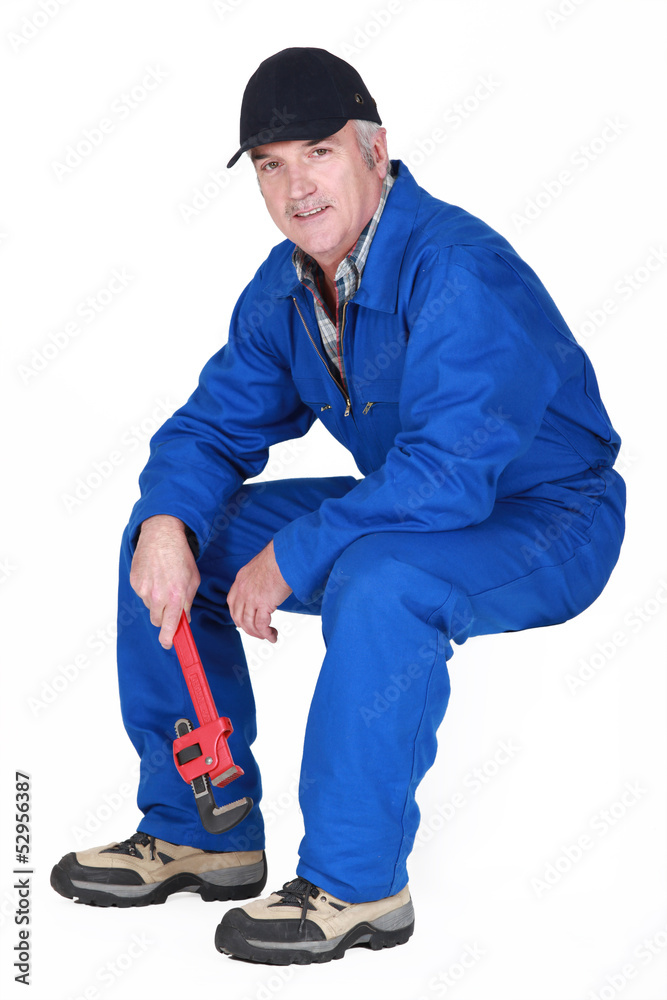 Middle-aged plumber sat down