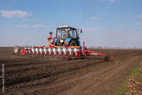 Tractor with sower on the field