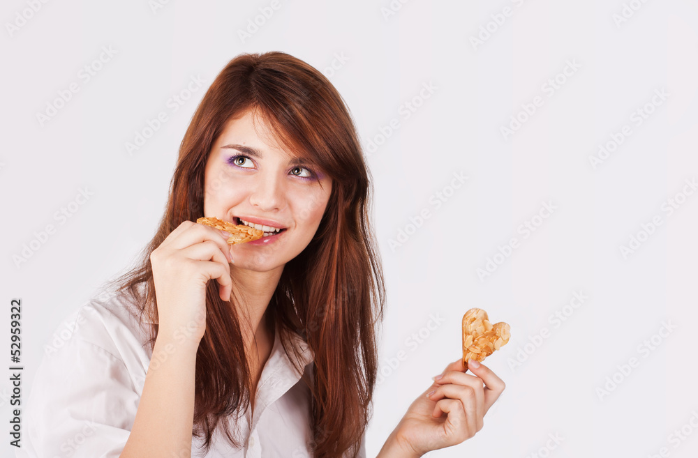 Portrait of young woman eating cookie Portrait of young woman eating cookie