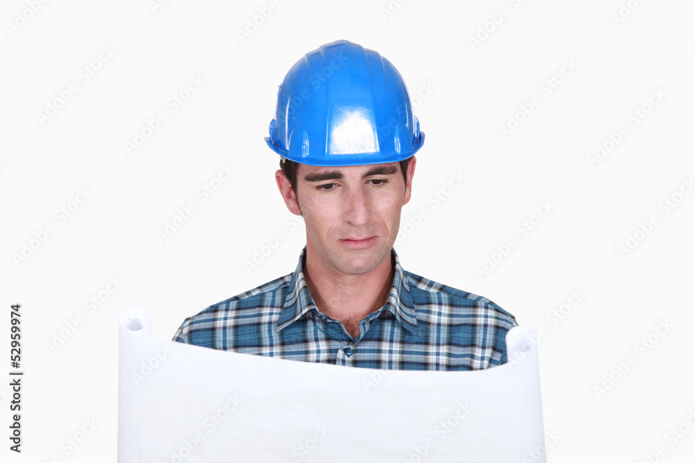A foreman checking plans. A foreman checking plans.