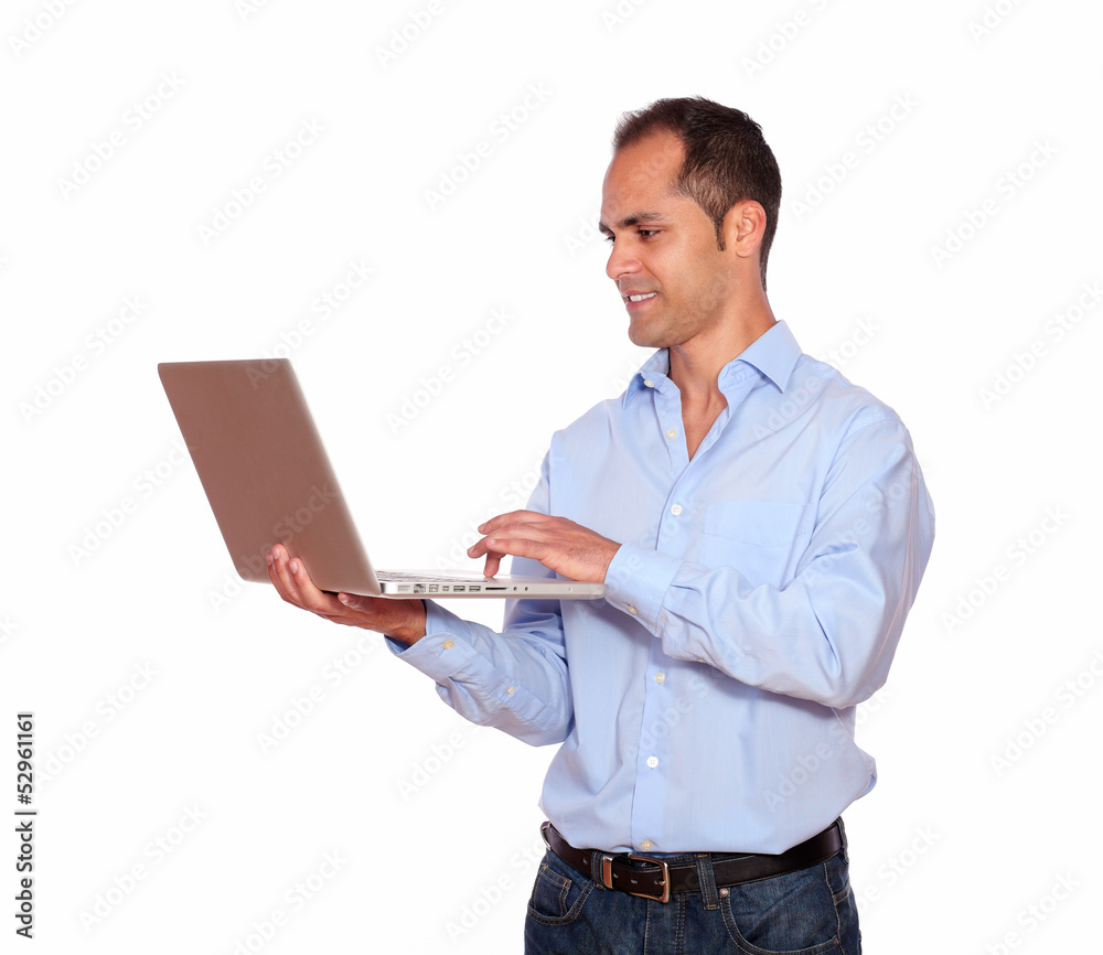 Charming adult man working on laptop computer Charming adult man working on laptop computer