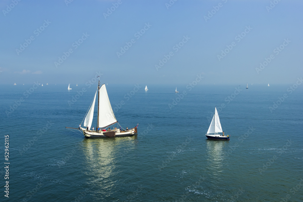 Seascape with big and small sailboats