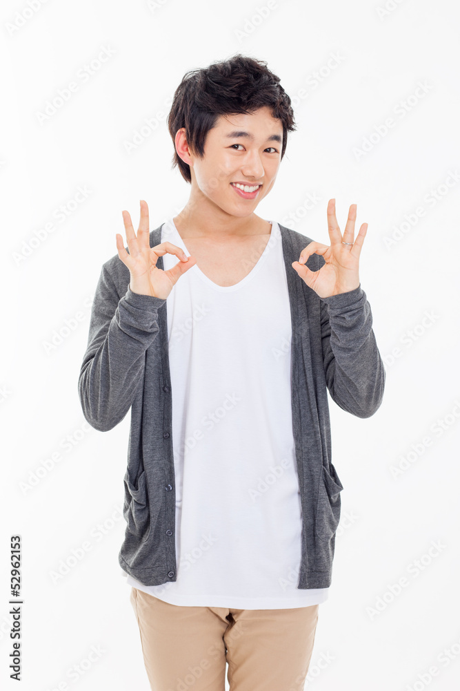 Young asian man showing okay sign. Young asian man showing okay sign.