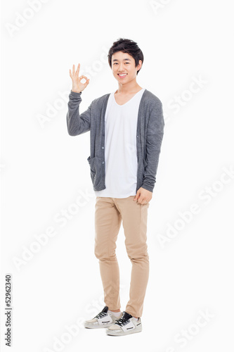 Young asian man showing okay sign.