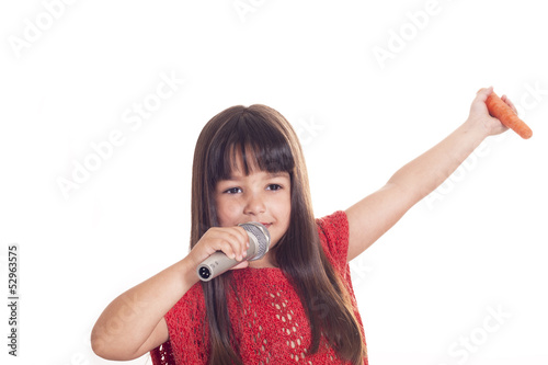 little girl wih microphone and carrot photo