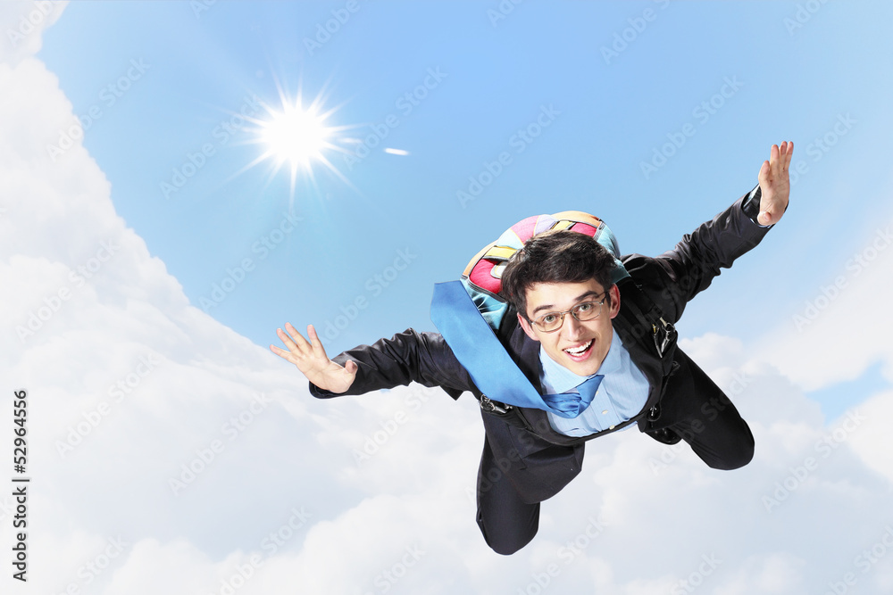 Young businessman flying with parachute on back Young businessman flying with parachute on back