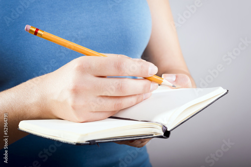 Woman Writing In Notebook