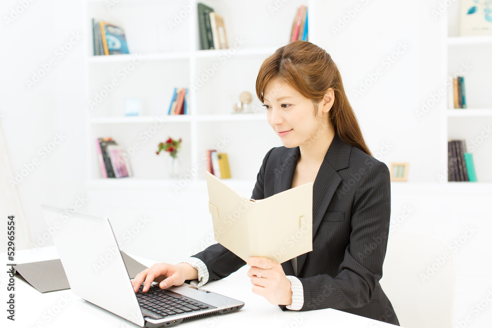 Beautiful young businesswoman working in office Beautiful young businesswoman working in office