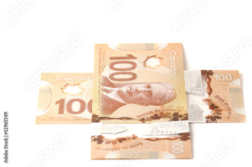 Two hundred Canadian dollar bills in a plus sign photo
