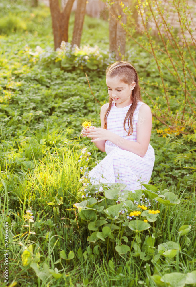 smiling girl wonders on flower, tearing petals smiling girl wonders on flower, tearing petals