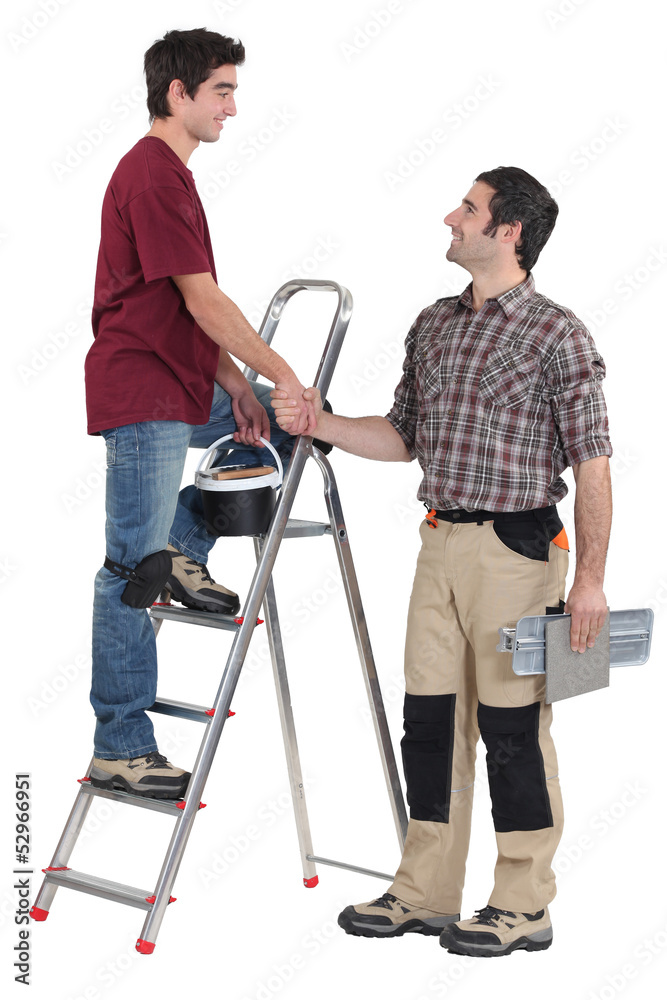 Two handymen shaking hands Two handymen shaking hands
