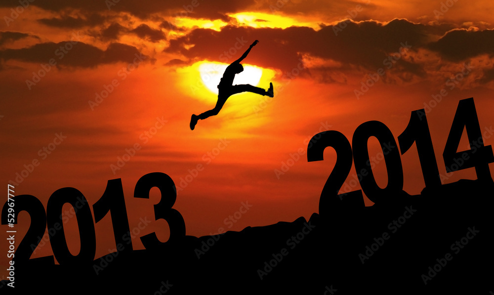 Amazing silhouette of man jumping at sunset toward 2014 Amazing silhouette of man jumping at sunset toward 2014