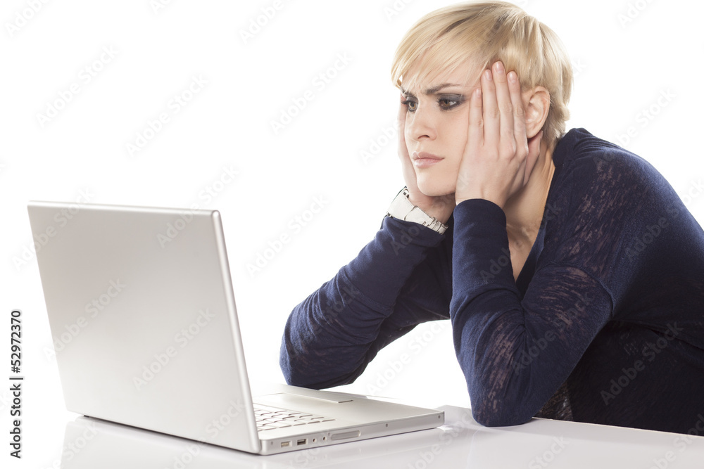 cute girl indifferently reading the content on the laptop cute girl indifferently reading the content on the laptop