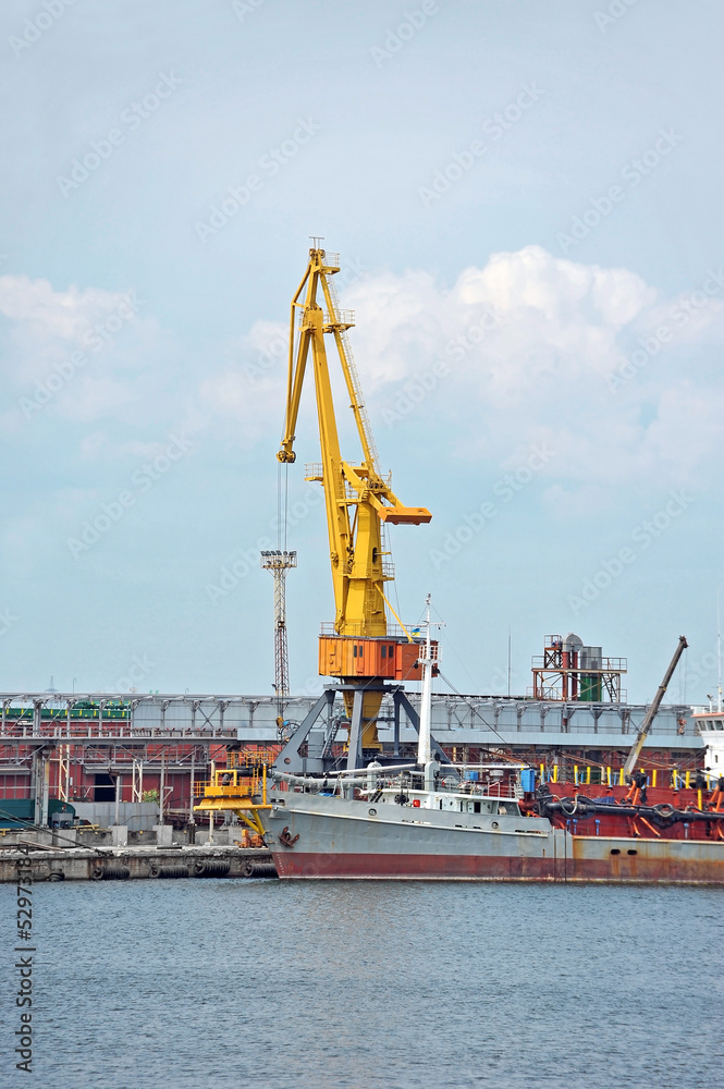 Bulk cargo ship under port crane bridge, Odessa, Ukraine Bulk cargo ship under port crane bridge, Odessa, Ukraine