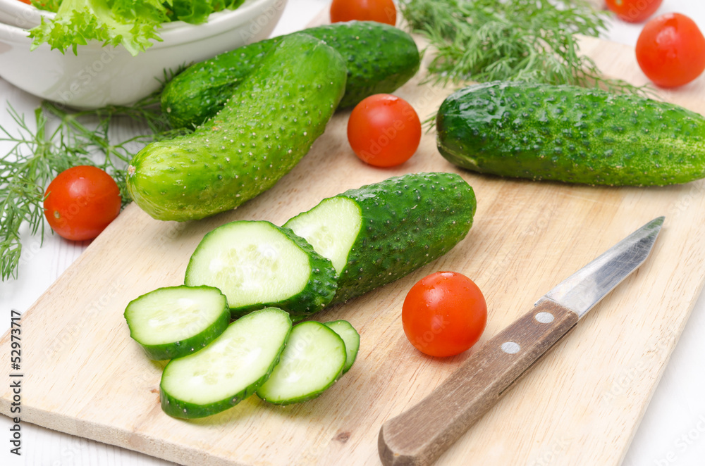 ingredients for salad - fresh cucumbers, tomatoes and herbs ingredients for salad - fresh cucumbers, tomatoes and herbs