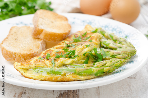 omelette with asparagus, greens and toast, selective focus
