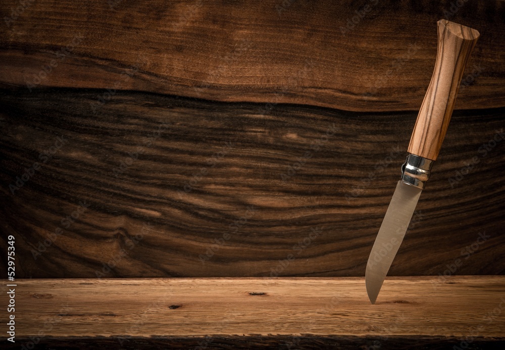Sharp knife on wooden background