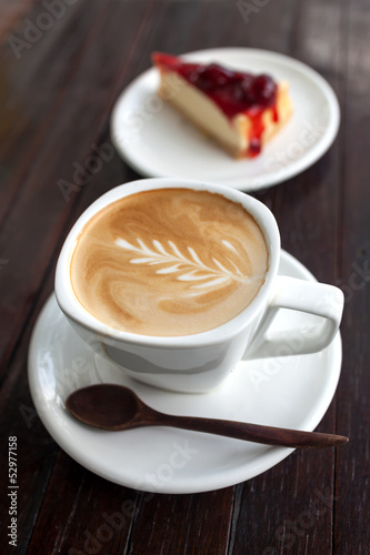 Cup of latte coffee with strawberry cheesecake