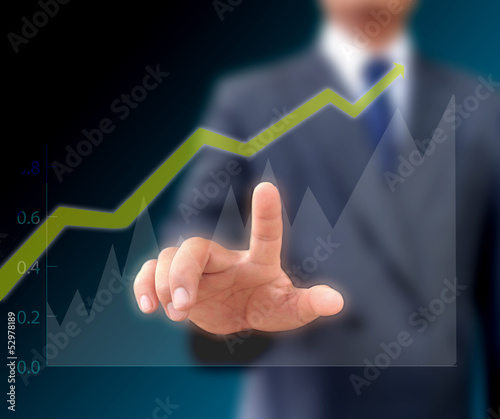 Businessman watching the upward trend of a graphic chart.