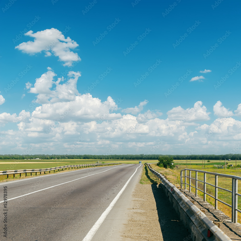 asphalt road to cloudy horizon