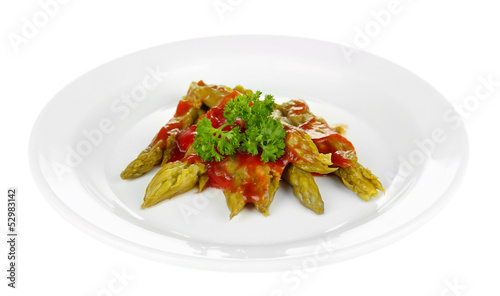Asparagus with tasty sauce on plate, isolated on white