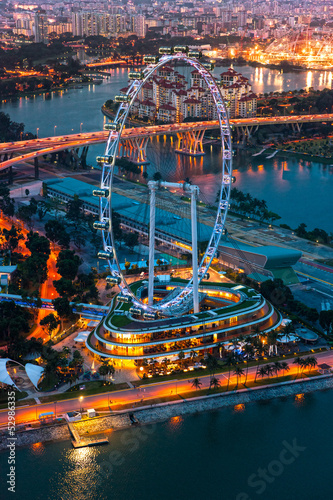 View of Singapore at night with the Singapore Flyer.