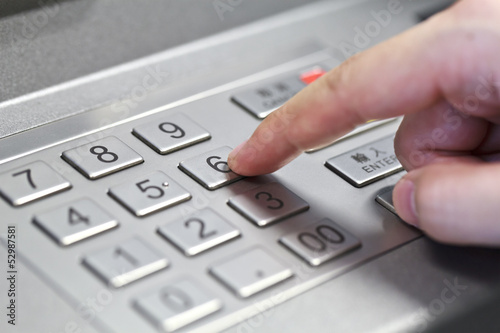 Human hand enter atm banking cash machine pin code
