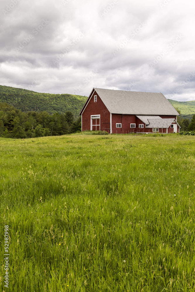 Farm landscape with red barn and pasture land