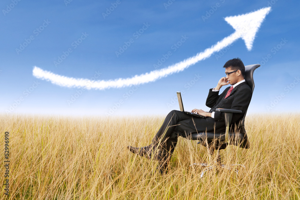 Businessman sit outdoor with success arrow sign Businessman sit outdoor with success arrow sign