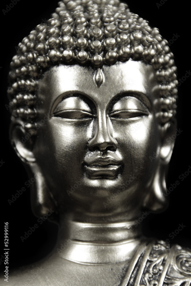 silver Buddha head on black background
